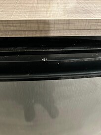 Cigarette burns on the refrigerator