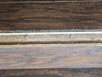 Nails exposed on stair inside front door.