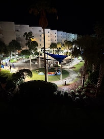 Night time view from balcony. You can see the ocean when standing on the far right.