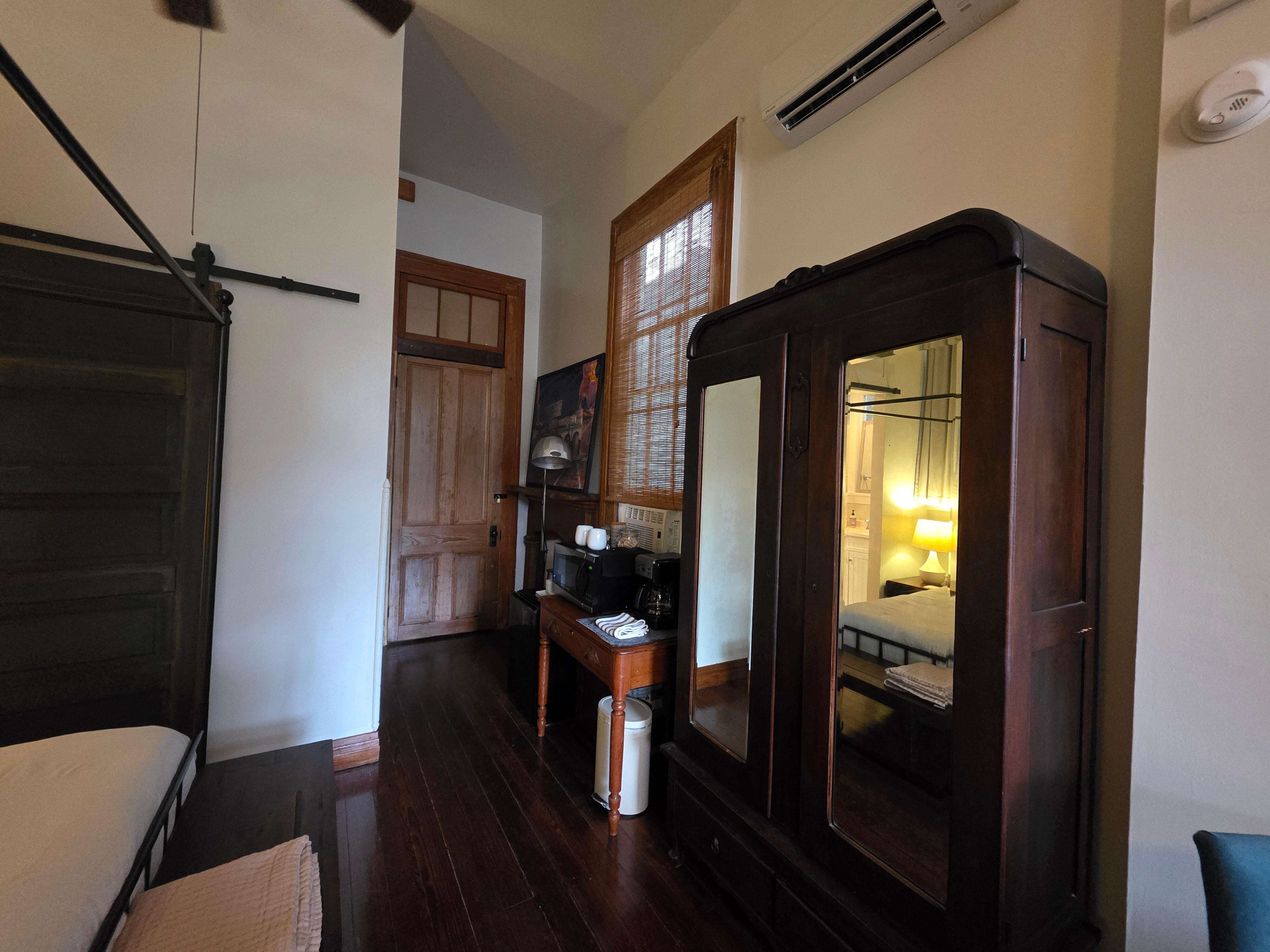 Coffee maker, mini fridge, microwave and wardrobe. 