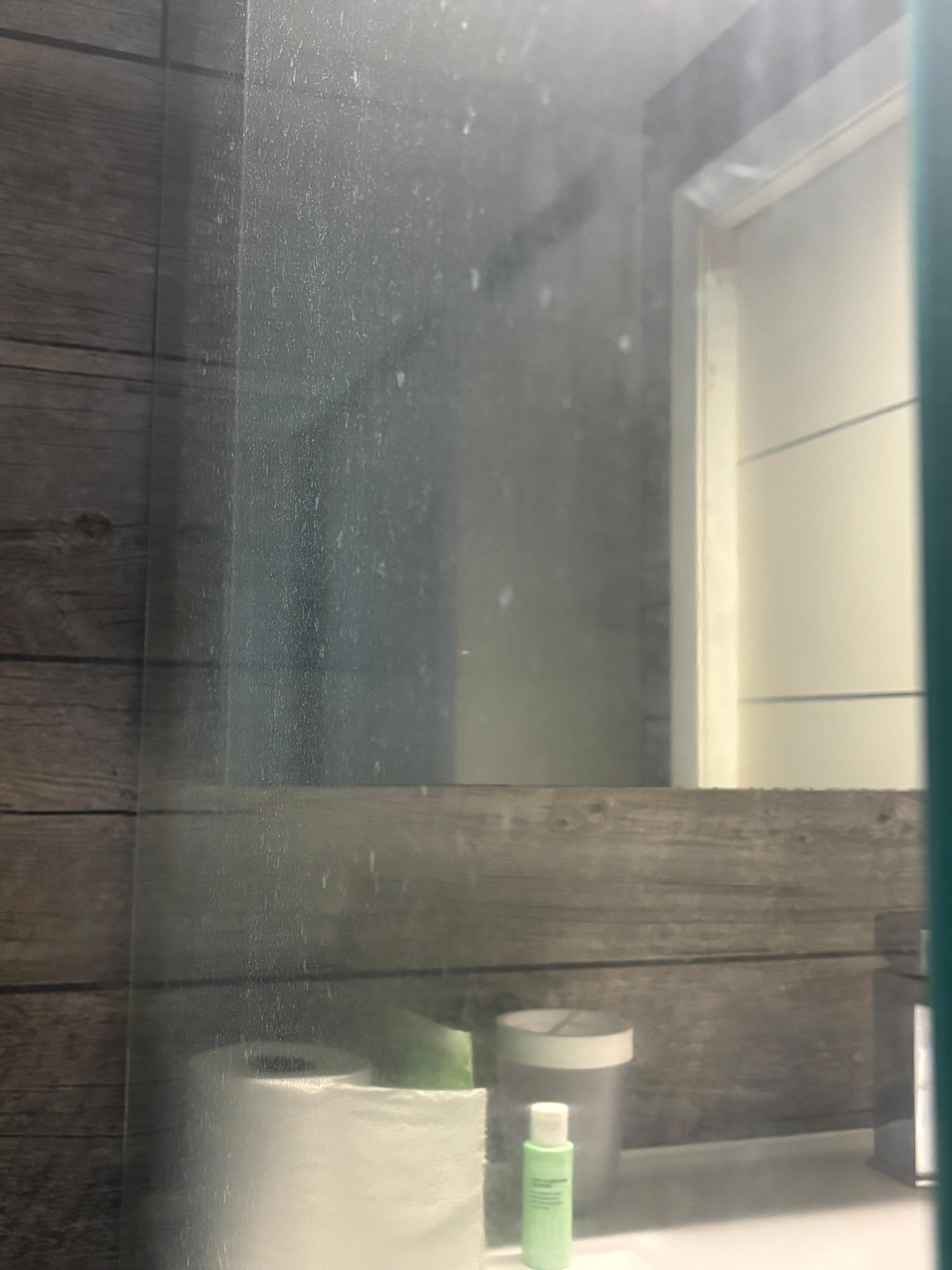 Soap scum on glass shower wall 