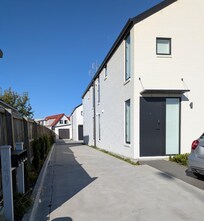 The property is at the end of this driveway, with parking for one car available in front of the garage.