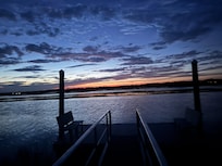 Sunset across the street over the inland waterway.