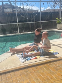 Siblings hanging by the pool