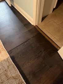 Flooring outside the problem toilet bathroom uneven from past water damage I would presume. Sounded like a reoccurring issue and looked it.