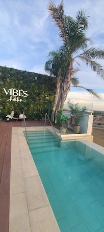 Pool side with bar upstairs.