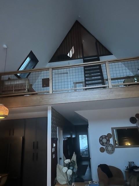 View from living room looking up to second level loft and bedroom. The door goes into the bedroom and the ladder goes up to the higher loft where there is a beanbag. 