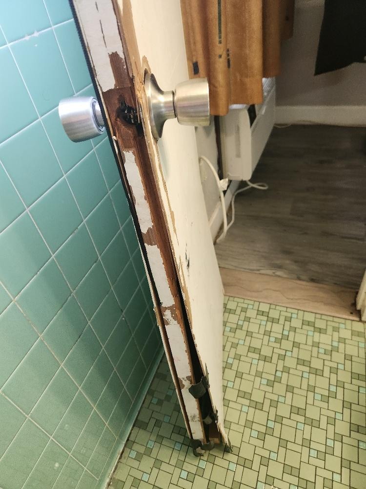 Bathroom door #1 - missing the piece to keep door closed in door frame and the door is all wrought out and falling apart