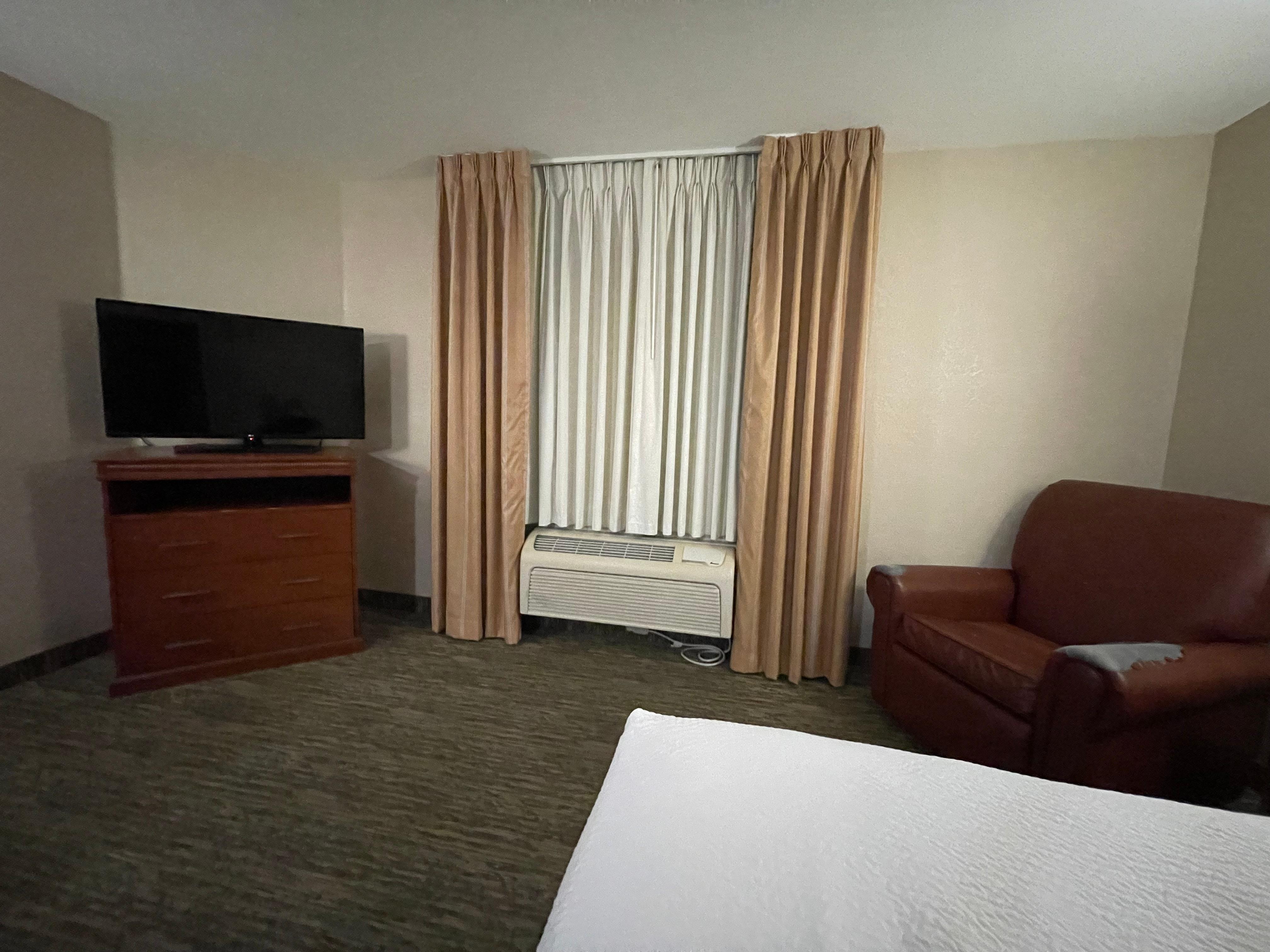 Trashed out chair near the bed.