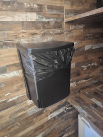 In closed cabinet with fridge and safe