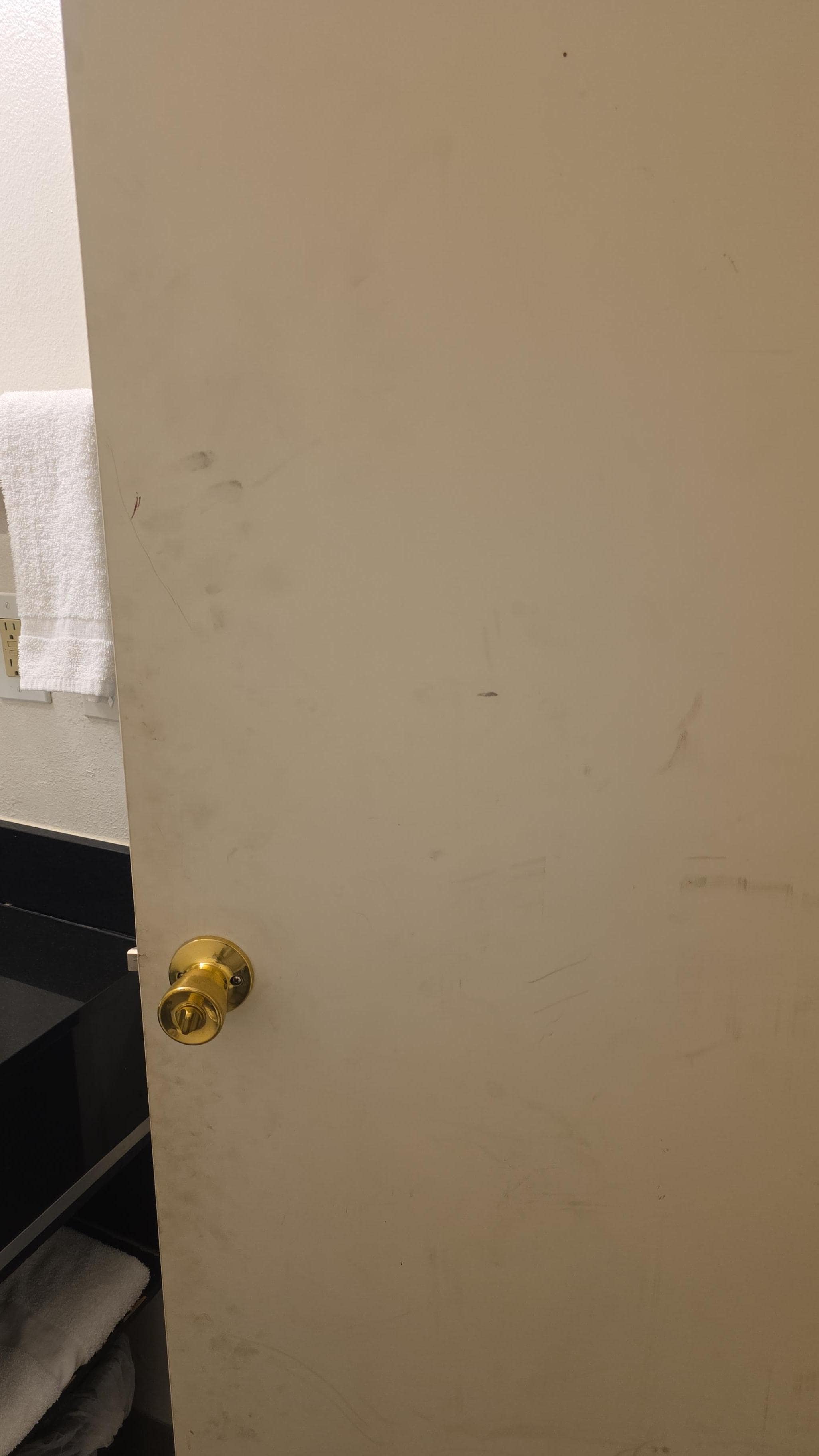 Dirty handprints all over the door and walls