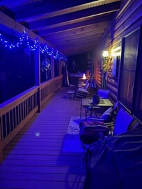 porch view at night with lights & fire pit