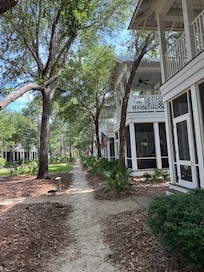 View of walkway by green space.