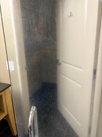 Shower door covered in soap scum