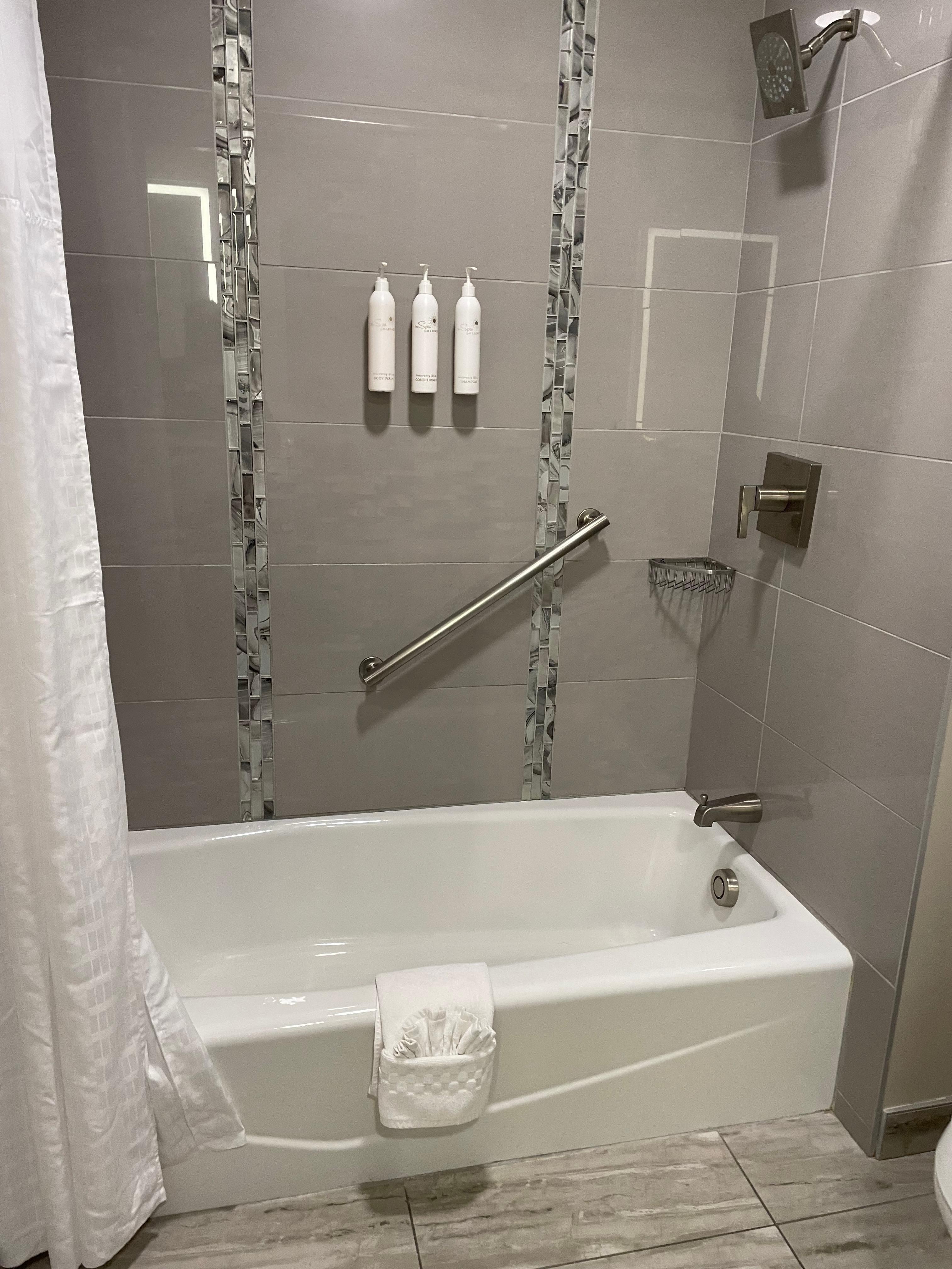 Bathtube/shower, toilet in another area of the bathroom