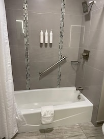 Bathtube/shower, toilet in another area of the bathroom