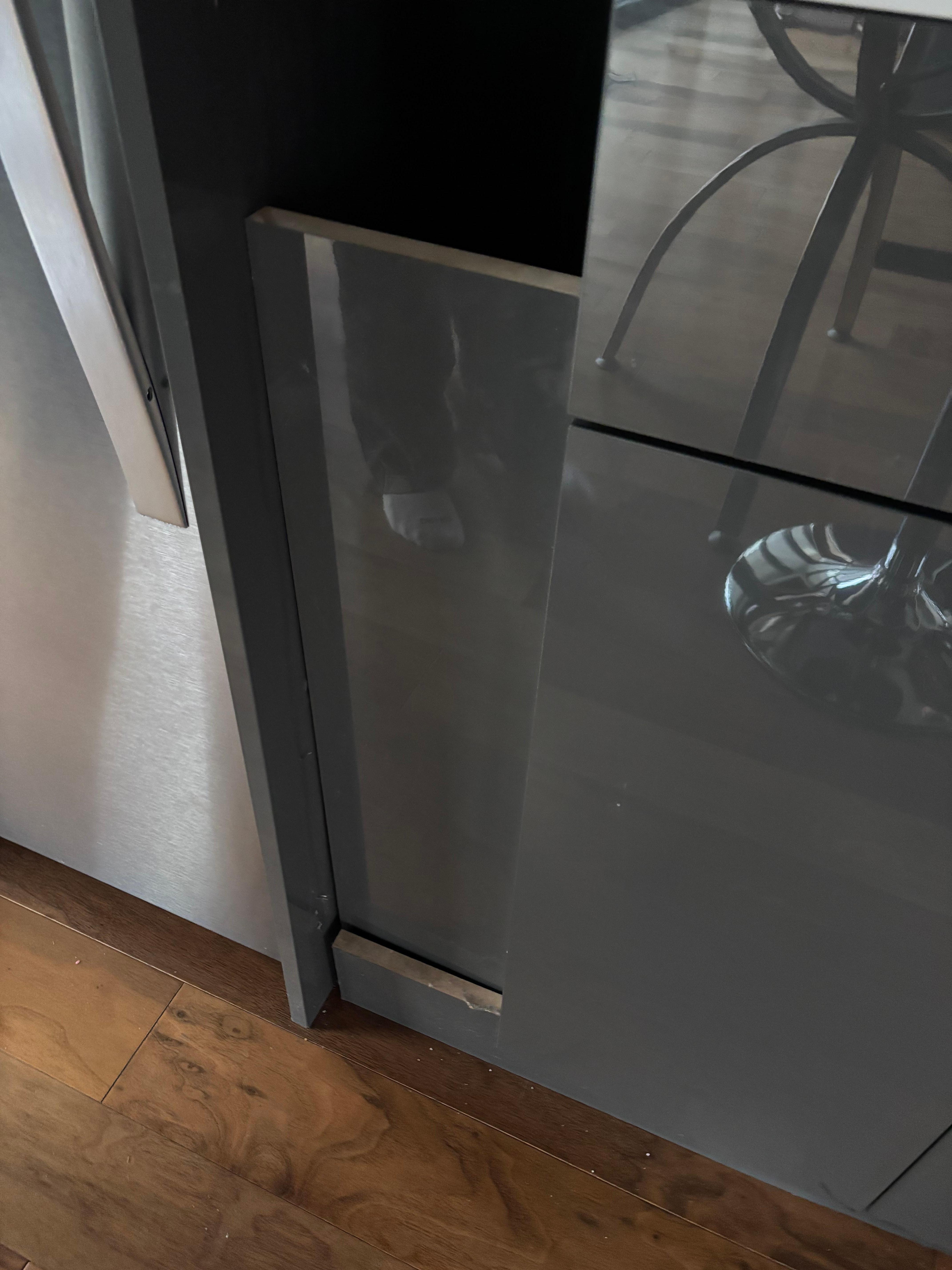 Filler piece between fridge & sink fell off with a “bang” while we were sleeping & woke us up!