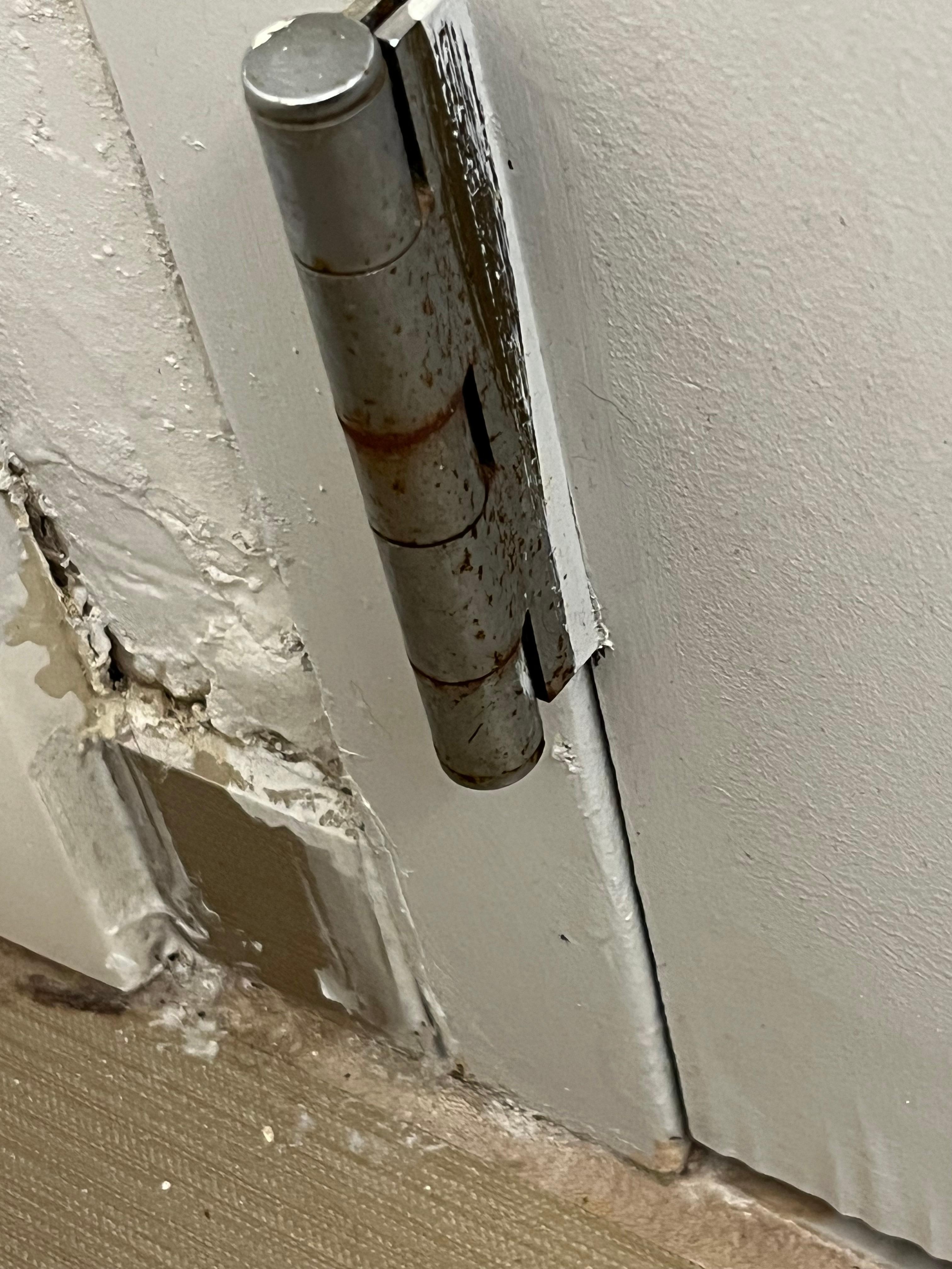 Bathroom wall by door.