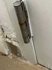 Bathroom wall by door.