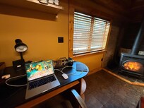 Office space near the kitchen and fireplace.