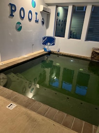 The water has a green hue due to the pool floor color.