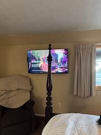 From the bed lol. I just unscrewed it so I could see the TV. But it back on when we left.