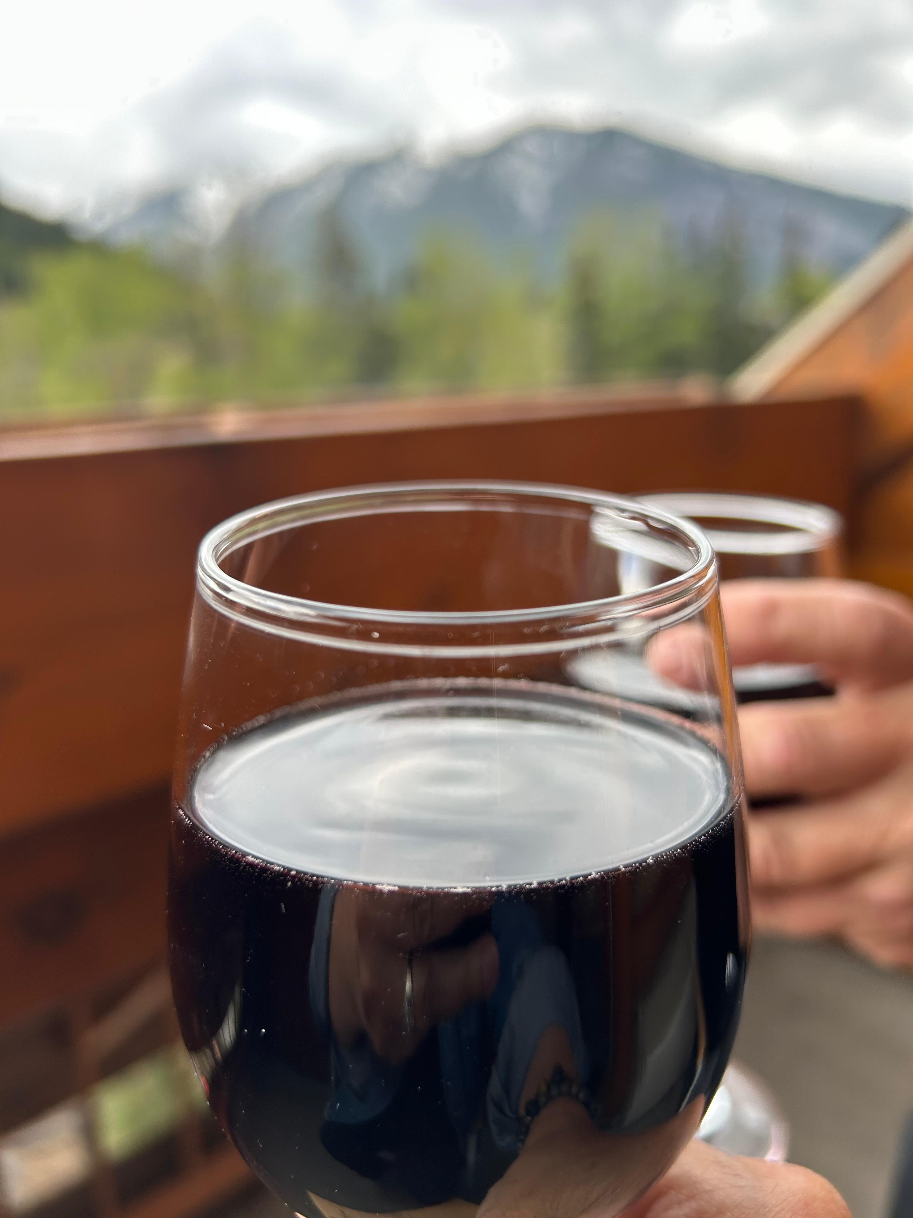 Glass of wine on our deck with mountain views!