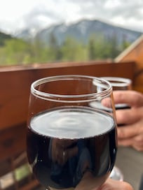 Glass of wine on our deck with mountain views!