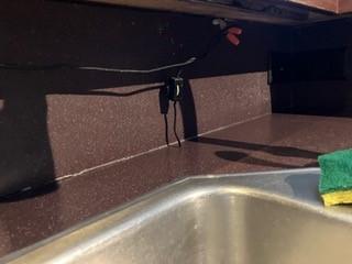 wire hanging down in kitchen by sink!