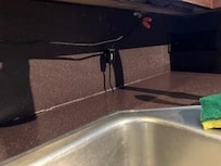 wire hanging down in kitchen by sink!