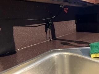 wire hanging down in kitchen by sink!
