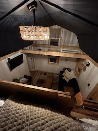 View of living space from the loft. Plenty of airflow from fan and A/C below.