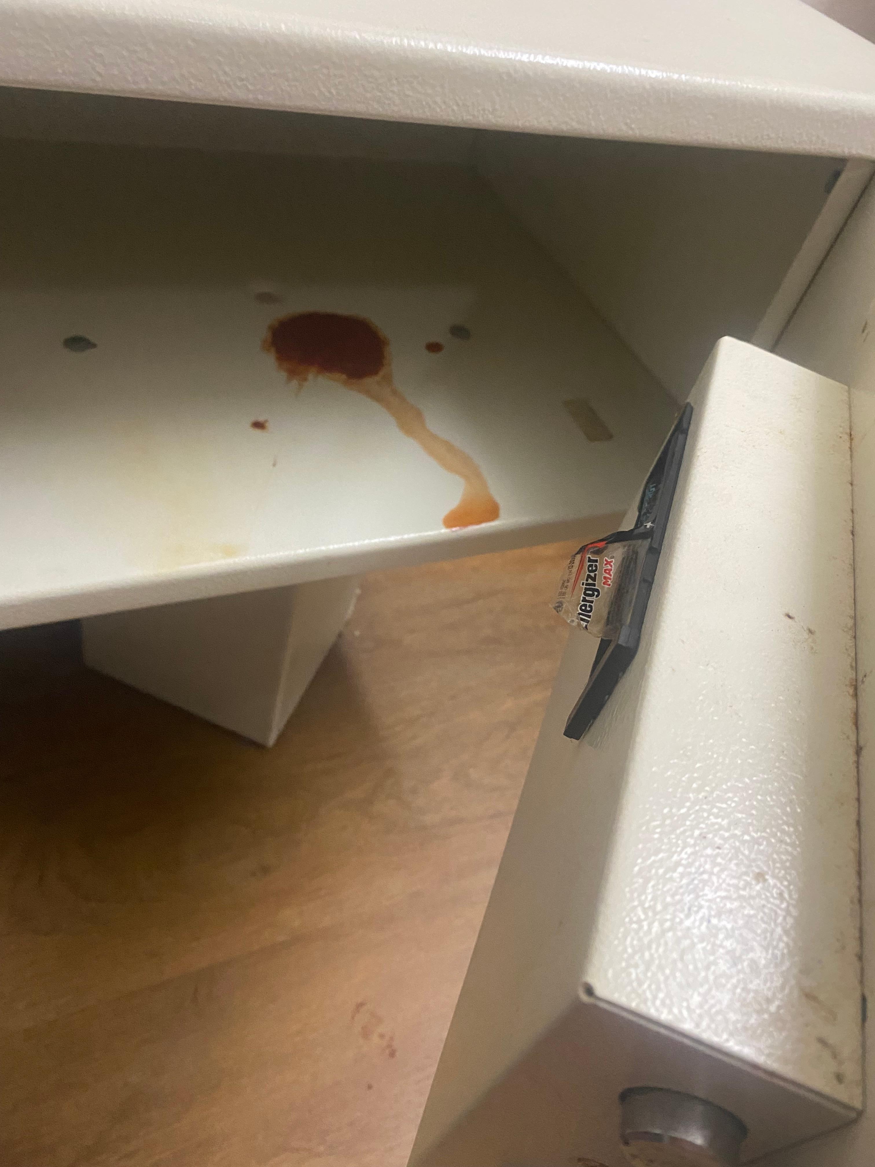 Something red spilled inside the safe.