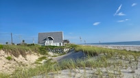 Dune and cute little house on the entrance