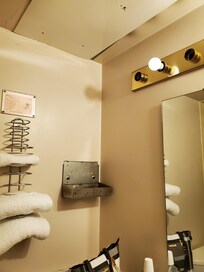 Sink and tub old and roof in bathroom has a hole covered by a white board