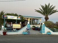 Stephanos Taverna across the highway at the bottom of the hill. Great food, great prices, great people! Family run. We ate here every night!