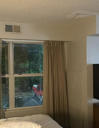 damaged ceiling near foot of bed & rusted air vents. water leak.
other parts of room were also in poor condition - large dents in refrigerator door, mildew in shower.