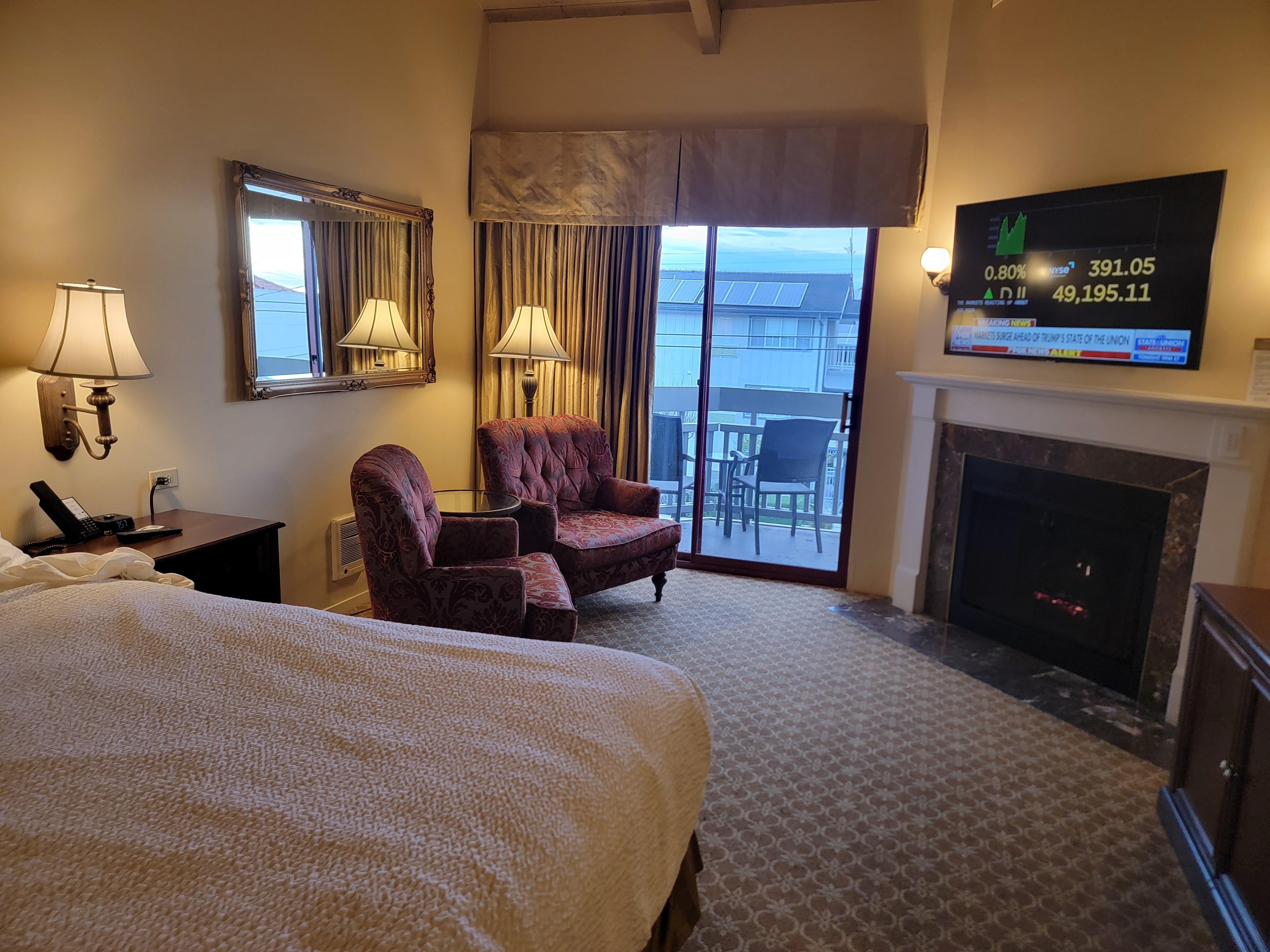 King bed with adjacent CoZy seating area and balcony