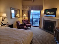 King bed with adjacent CoZy seating area and balcony