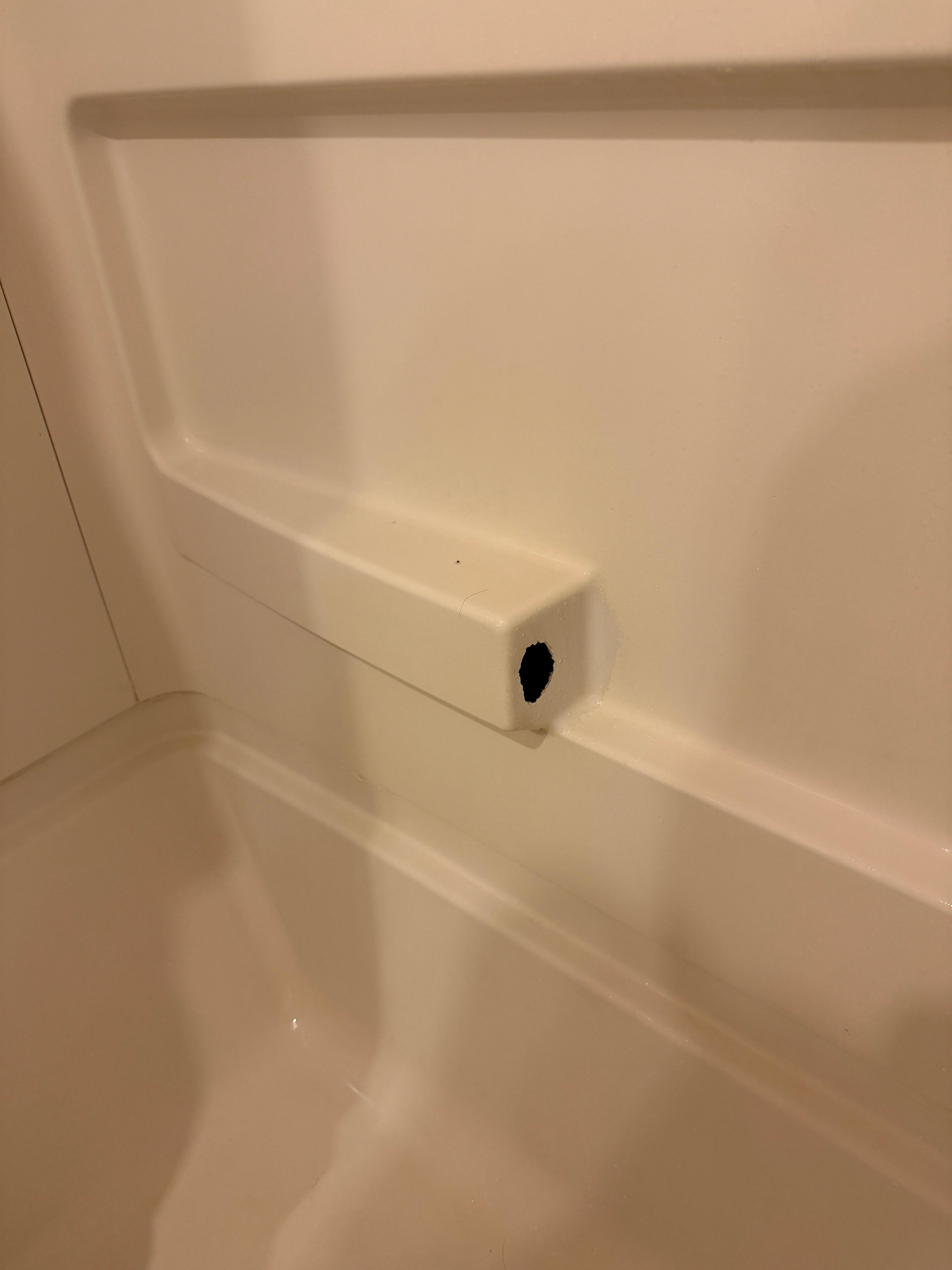 hole in bathtub enclosure