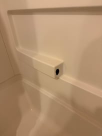 hole in bathtub enclosure