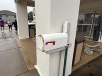 This unattractive mailbox with rust is right by the front entrance.