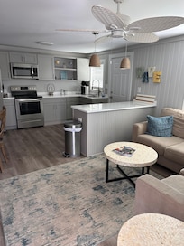 Living/ kitchen area. Large sectional couch. Smart TV.