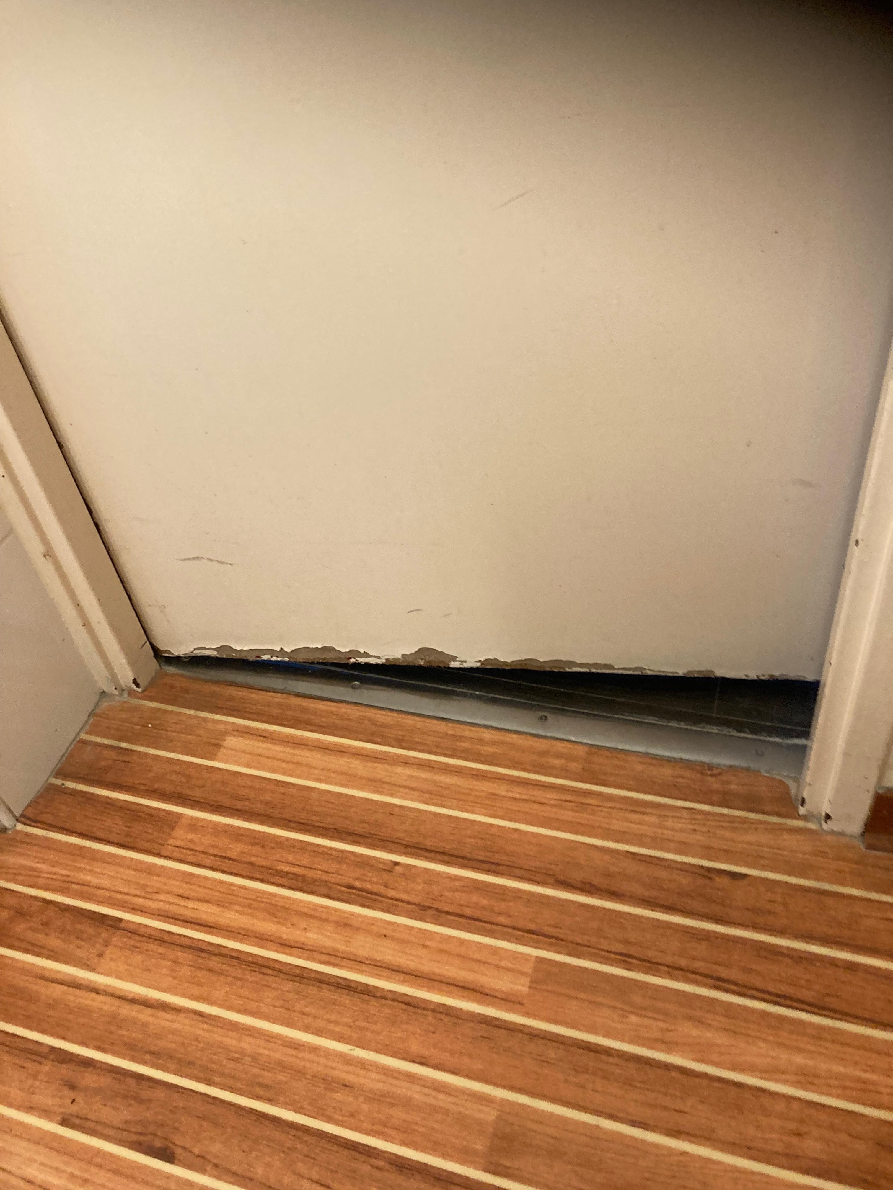 Bathroom door rotting-away