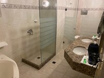 Large bathroom with bath, shower and double basins