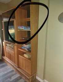 Entertainment center leaning forward away from wall/ not anchored