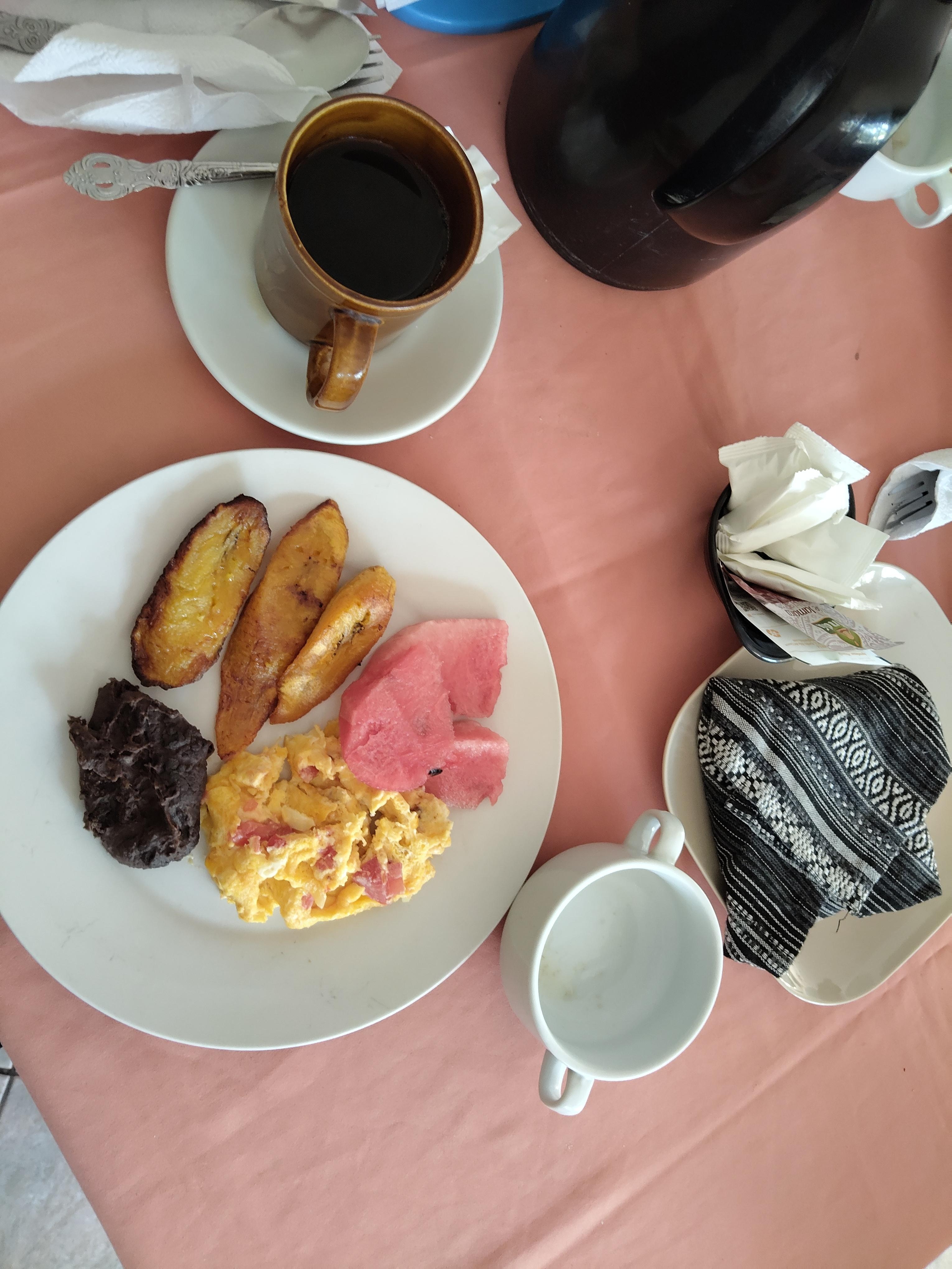 Guatemalan breakfast. Eggs, beans, plantains and fruit. A side of warm avena and unlimited coffee