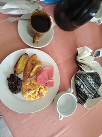 Guatemalan breakfast. Eggs, beans, plantains and fruit. A side of warm avena and unlimited coffee