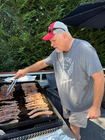 Our older son grilling bacon for the whole gang