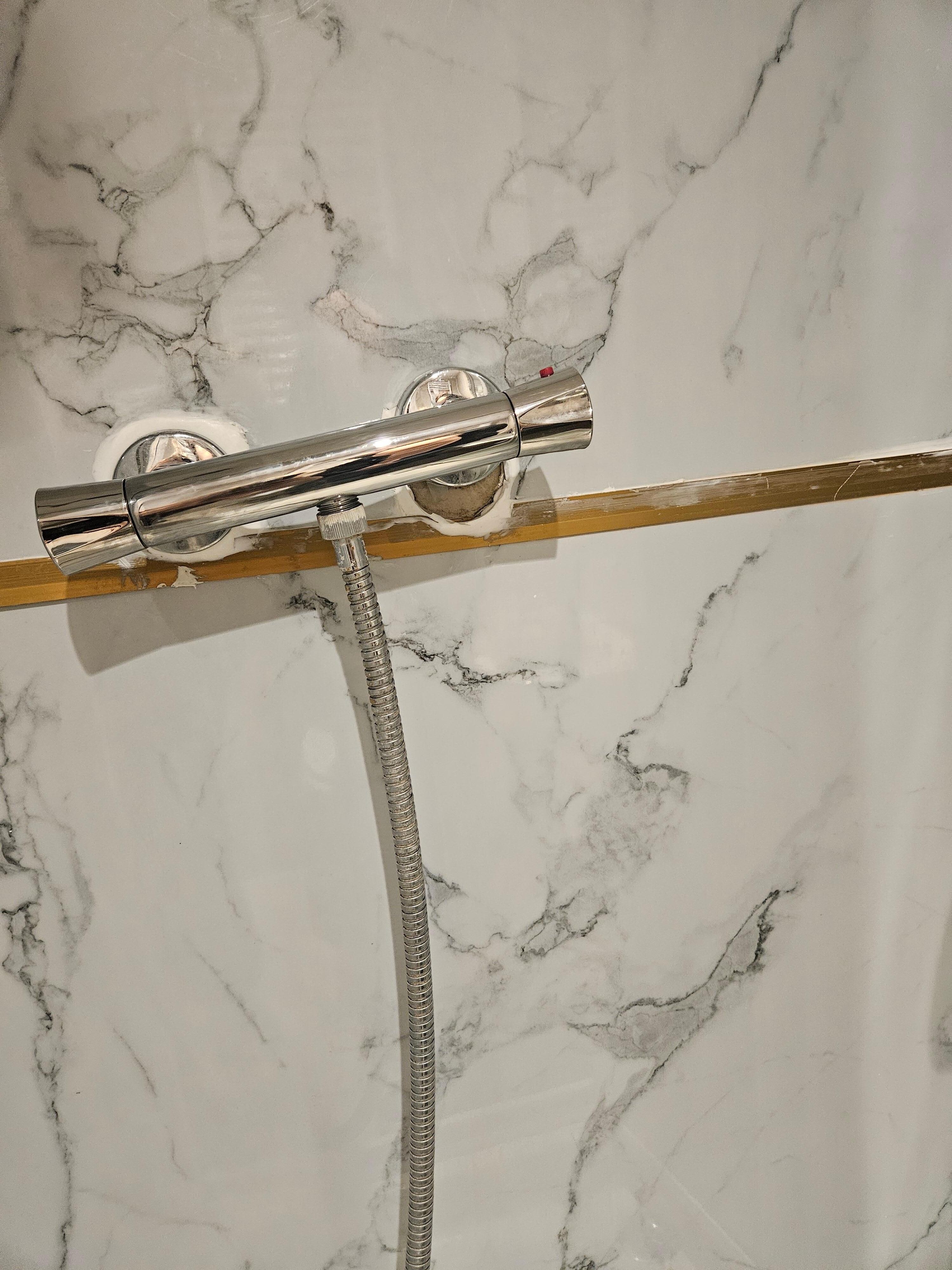 The handle to run the shower was not fully attached to the wall.